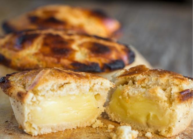 Pastries with creamy filling on a wooden board.